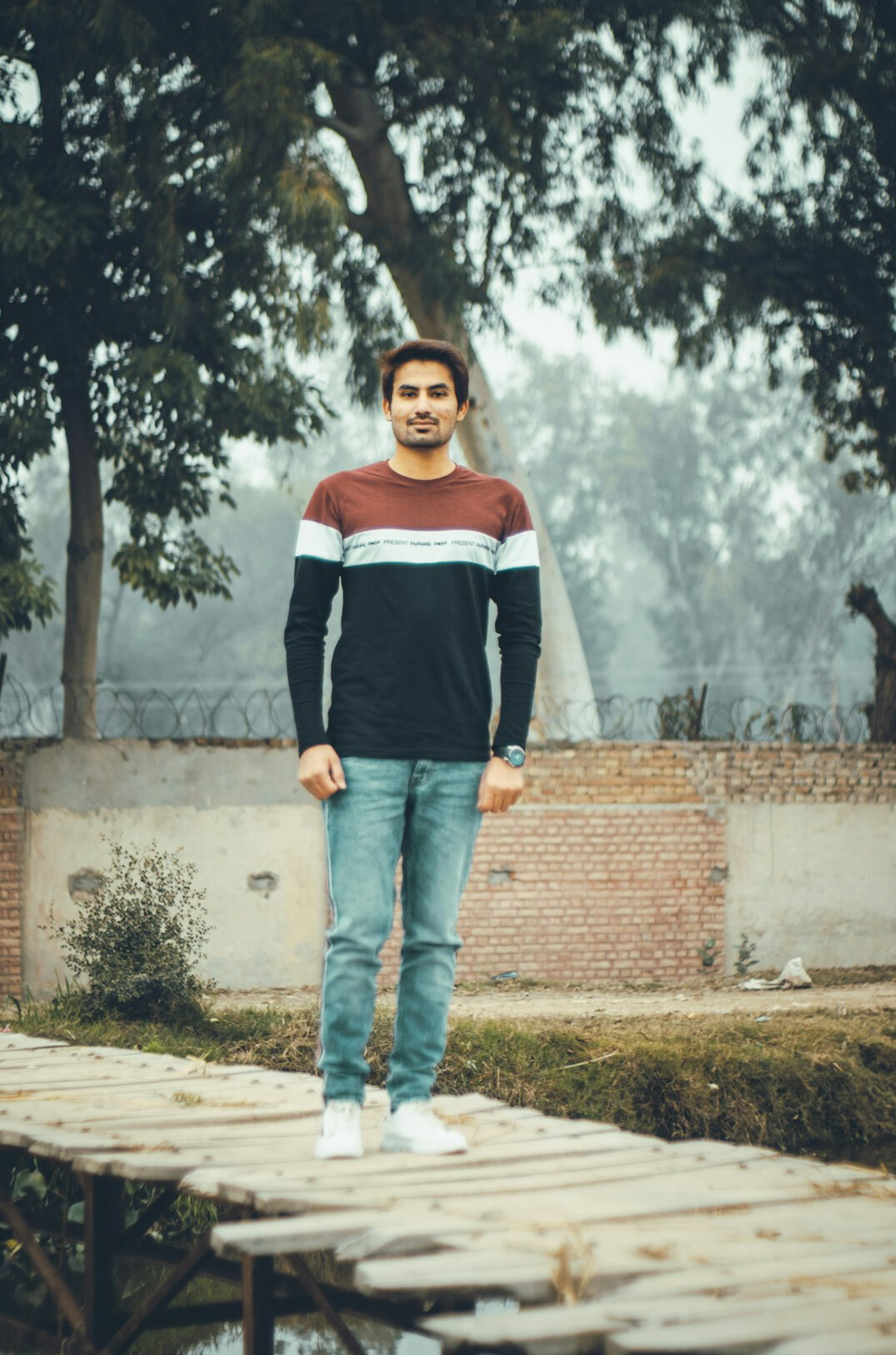 Smiling young man in casual clothes looking at the camera